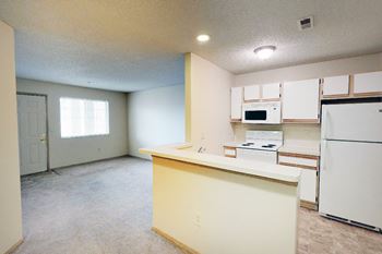 Kitchen with white cabinetry and appliances